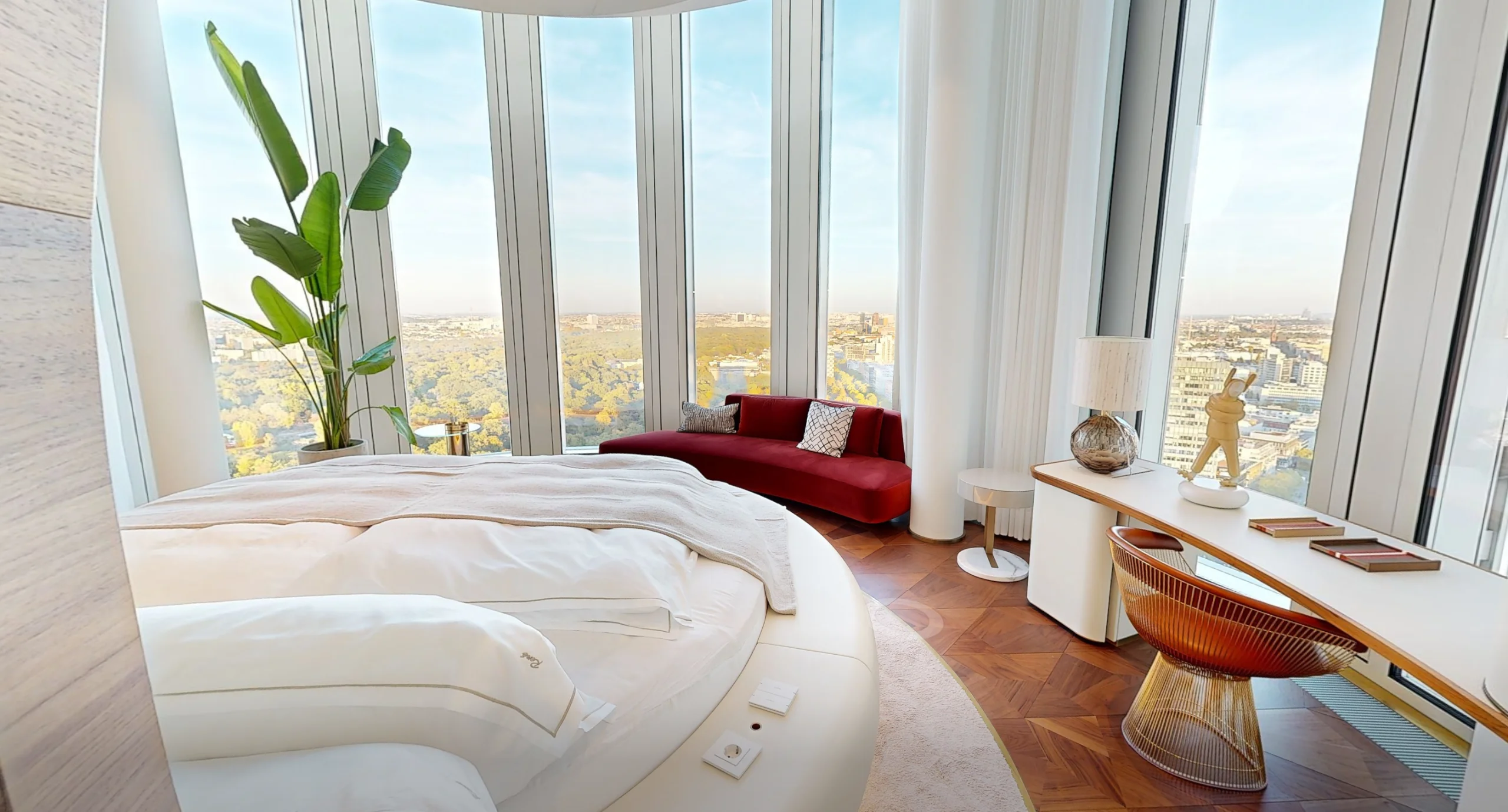 Master suite with round bed and panoramic Berlin view